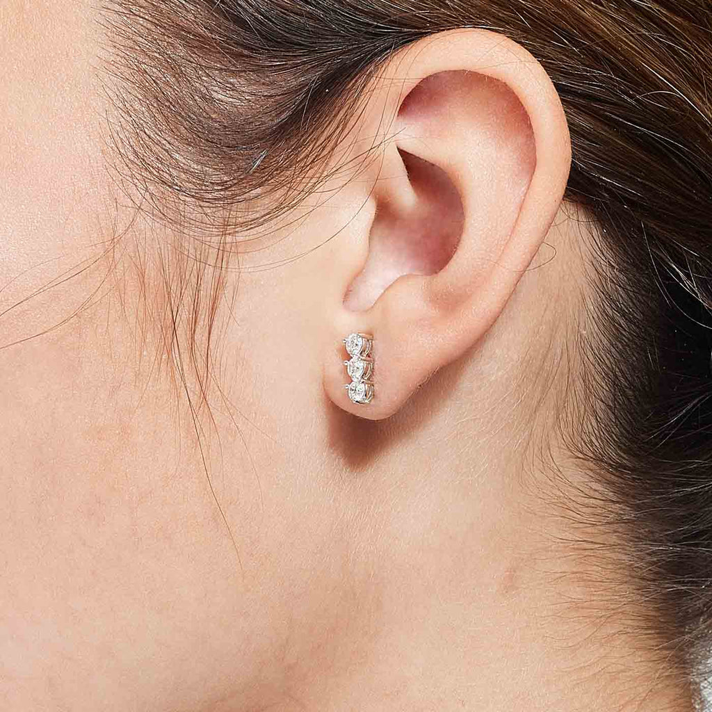 The Ecksand Three-Diamond Bar Earrings shown with  in 