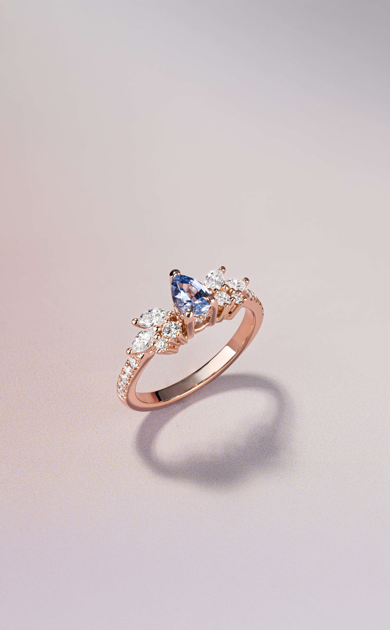 Canadian-made engagement ring with a pear sapphire and diamond cluster set in 14K rose gold.