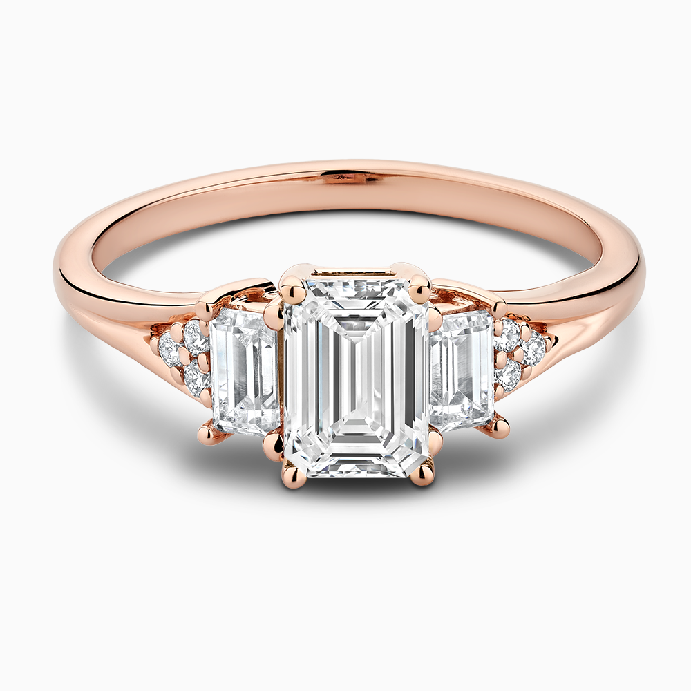 The Ecksand Three-Stone Engagement Ring with Side Diamonds shown with Emerald in 14k Rose Gold