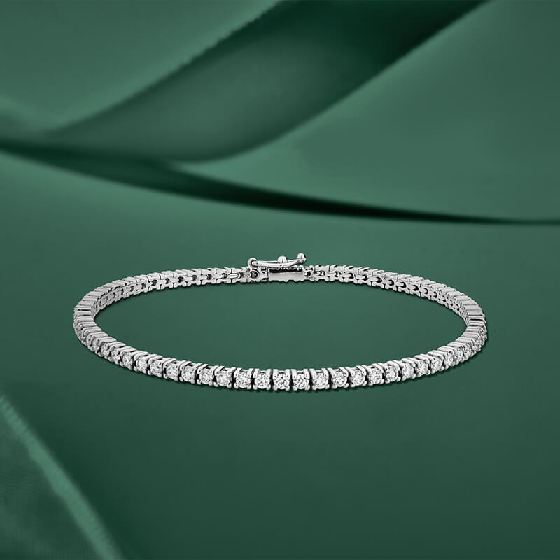 ecksand white gold tennis bracelet with diamonds on green background