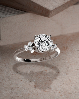The Iconic Ecksand Round Diamond Engagement Ring with Six Side Diamonds