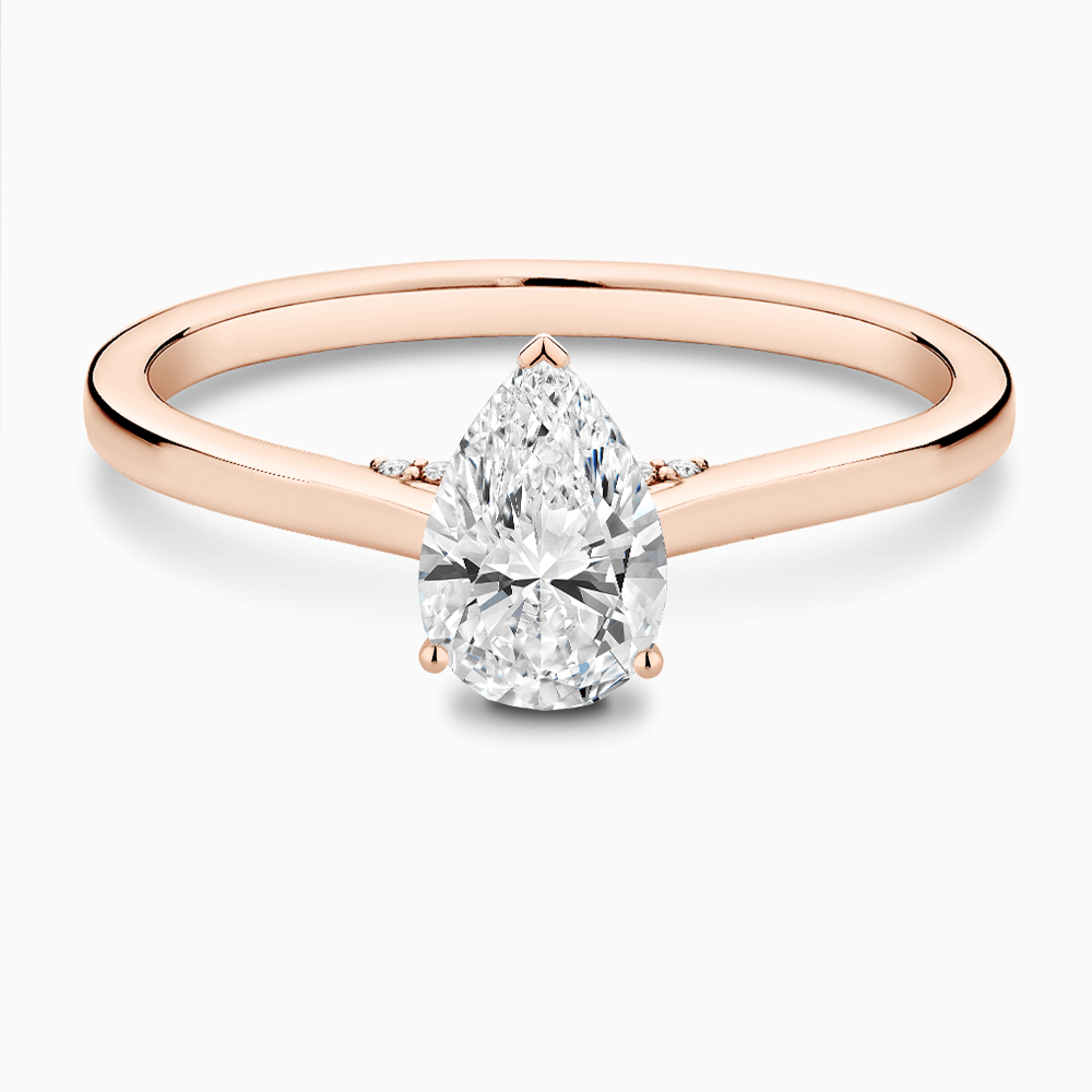 The Ecksand Solitaire Engagement Ring with Diamond Pavé Bridge and Hidden Diamond shown with Pear in 14k Rose Gold