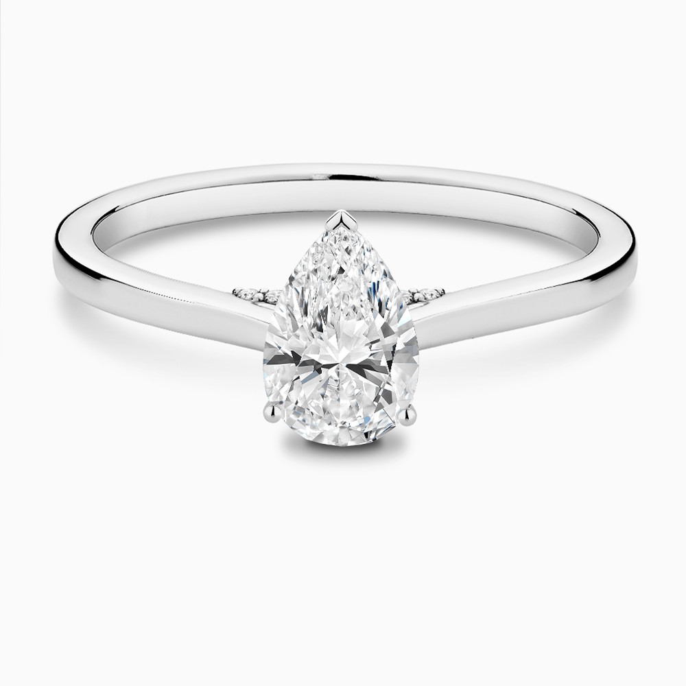 The Ecksand Solitaire Engagement Ring with Diamond Pavé Bridge and Hidden Diamond shown with Pear in 18k White Gold