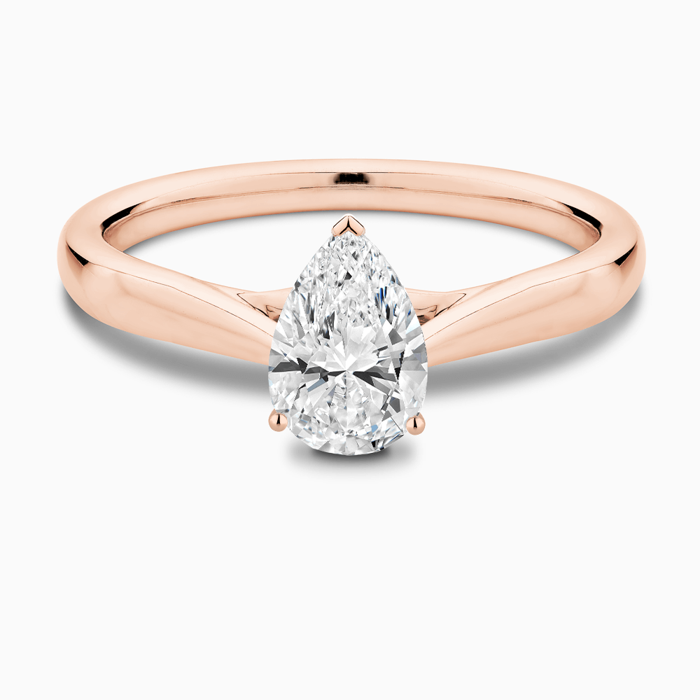 The Ecksand Iconic Tapered Band Solitaire Diamond Engagement Ring with Secret Heart shown with Pear in 14k Rose Gold