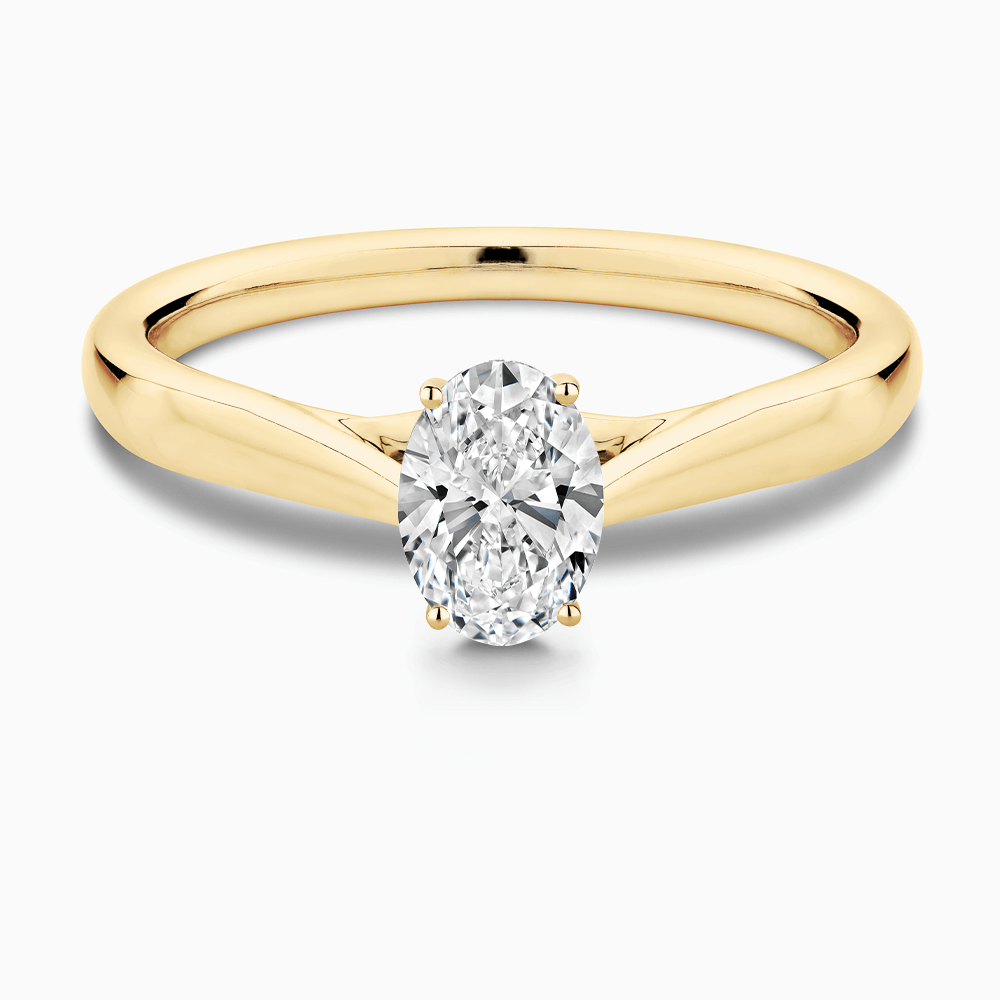 The Ecksand Iconic Tapered Band Solitaire Diamond Engagement Ring with Secret Heart shown with Oval in 18k Yellow Gold