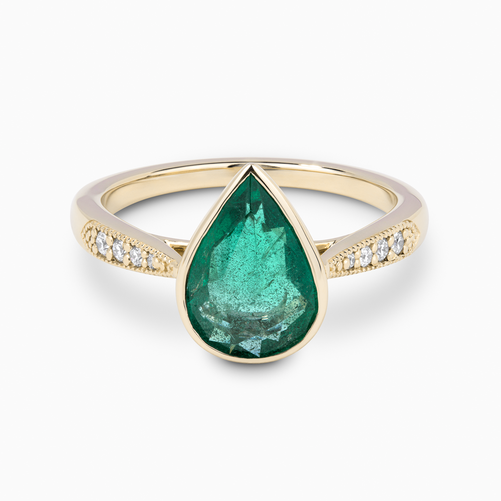 The Ecksand Emerald Engagement Ring With Tapered Diamond Band shown with  in 18k Yellow Gold
