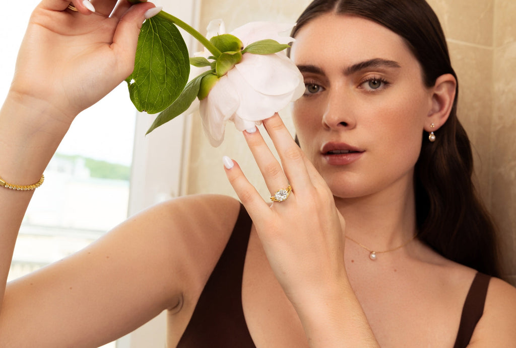 Model wearing wonder 14k yellow gold fine jewelry with diamonds and akoya pearls
