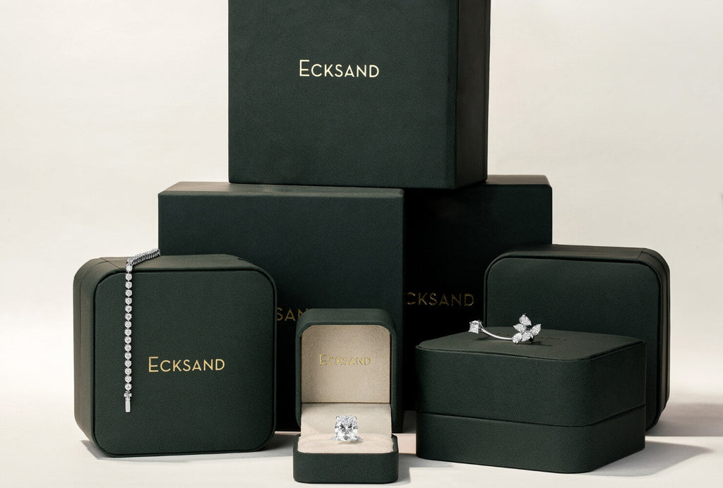 A collection of Canadian-made Ecksand diamond jewelry including an engagement ring, bracelet, and white gold earrings.