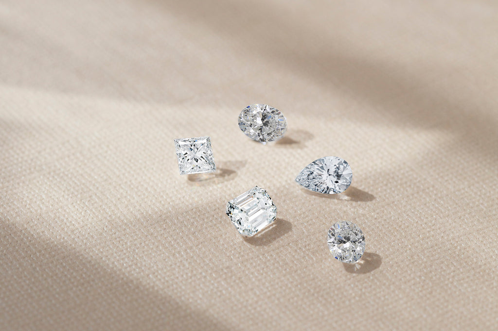 A front-facing photo of five diamonds on a table.