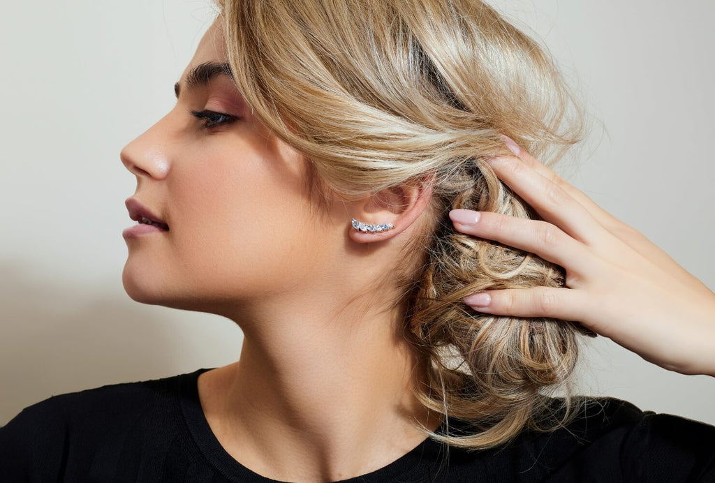 Ecksand Canadian-made diamond ear climber earrings in 18K white gold worn on a model with blonde hair.