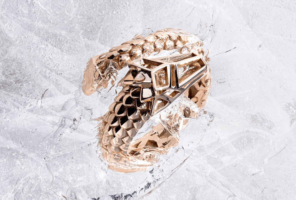 Canadian-made serpent statement bracelet in 14K Rose Gold. This unique Ecksand piece has a geometric design and rests on ice.