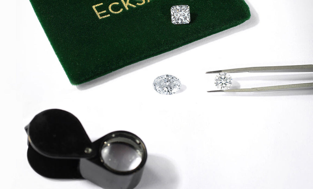 A photo of diamonds next to packaging and tweezers.