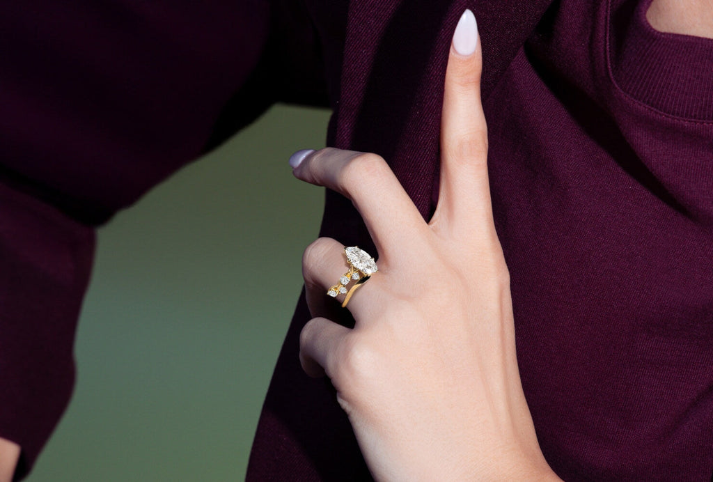 model wearing a marquise engagement ring with pave band