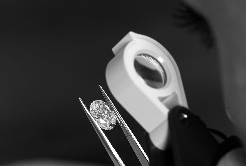 A jeweler inspects an oval diamond for a Canadian-made engagement ring at Ecksand's Montreal atelier.