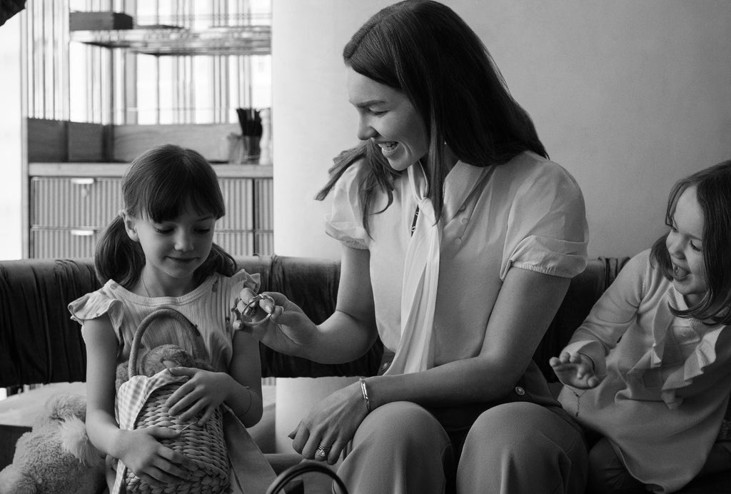 A mother and daughter share a special moment in this black and white photo featuring Canadian-made Ecksand earrings.