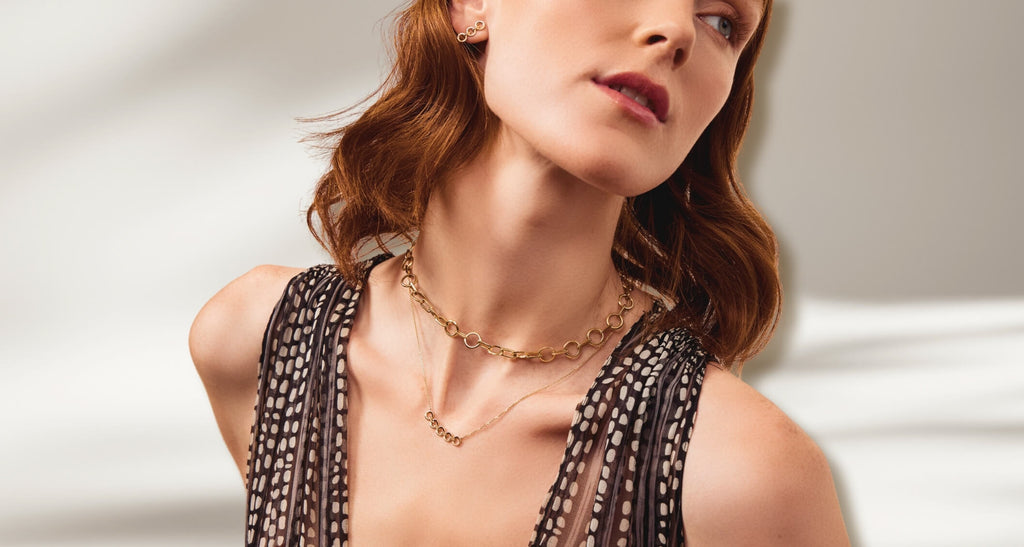 ecksand gold chain necklace on model on gray background