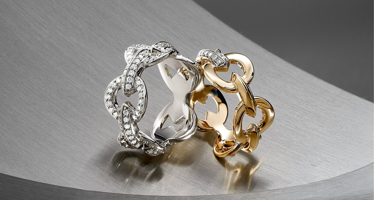 two canadian-made ecksand duel chain collection rings, one 18k white gold chain ring with diamond pave, one 18k yellow gold chain ring with a white gold link with diamond pave