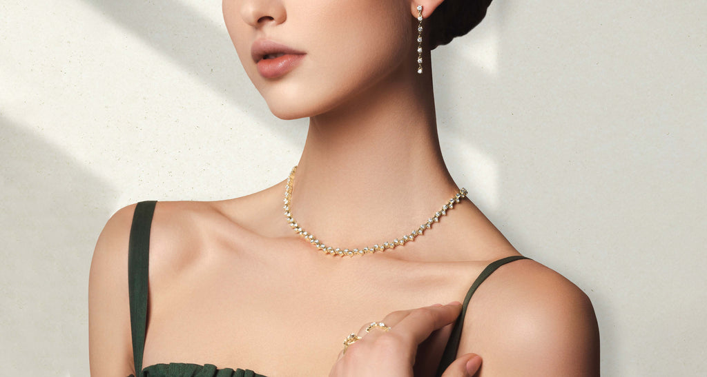 ecksand gold diamond necklace on model on gray background