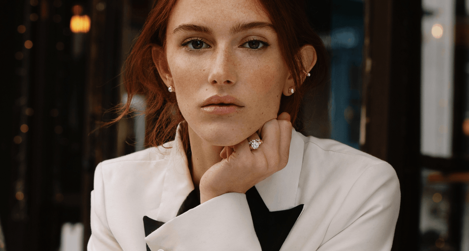model wearing canadian-made 14k rose gold interlocking diamond wedding ring paired with a round diamond centre engagement ring with side diamonds