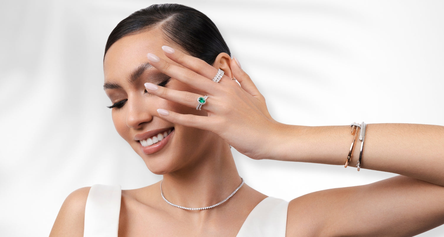 ecksand model wearing gemstone emerald engagement ring