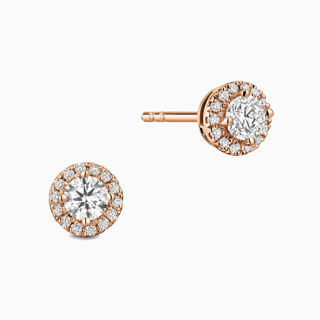 Angled view of Ecksand's Diamond Halo Stud Earrings in 18k Rose Gold, Natural VS2+/ F+