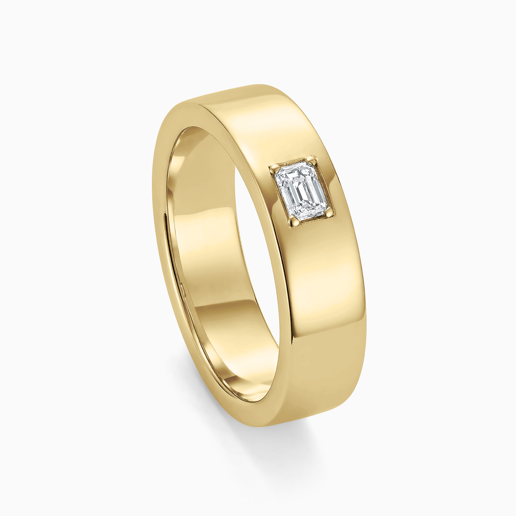 Angled view of Ecksand's Flat Wedding Ring with Baguette Diamond in 18k Yellow Gold, Lab-grown VS2+/ F+