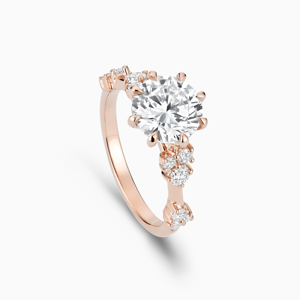 Angled view of Ecksand's Eight-Prong Blossom Engagement Ring with Side Diamonds in 14k Rose Gold, Round #2