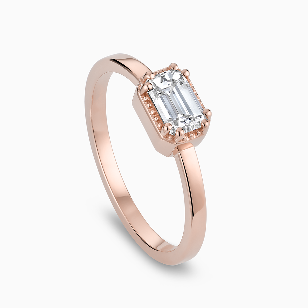 Angled view of Ecksand's Emerald Diamond Stackable Ring with Milgrain Halo in 18k Rose Gold, Lab-grown VS2+/F+