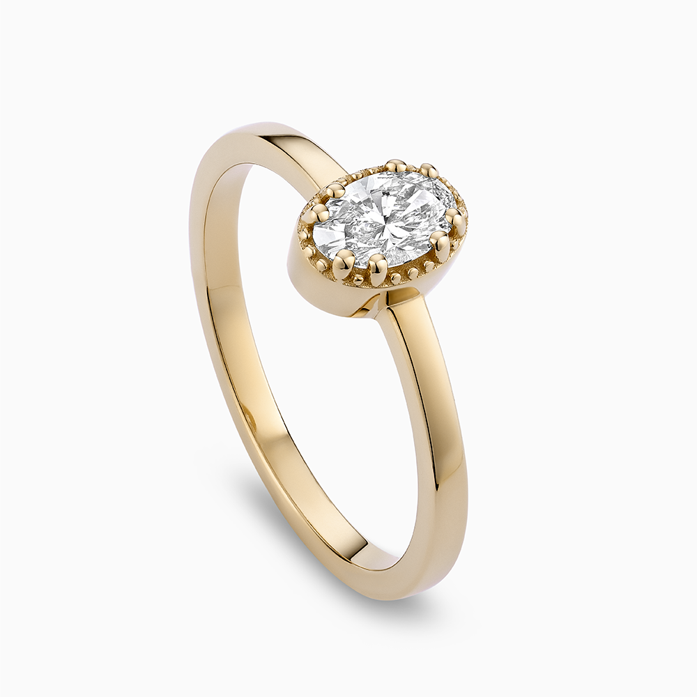 Angled view of Ecksand's Oval Diamond Stackable Ring with Milgrain Halo in 18k Yellow Gold, Lab-grown VS2+/F+