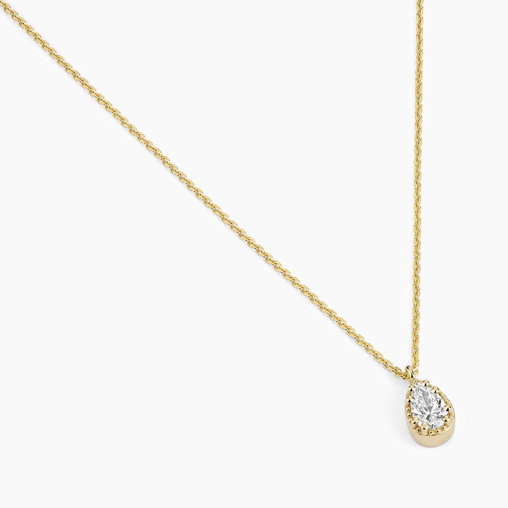 Angled view of Ecksand's Pear Diamond Stackable Necklace with Milgrain Halo in 18k Yellow Gold, Lab-grown VS2+/F+