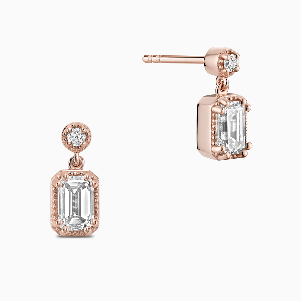 Face view of Ecksand's Emerald Diamond Stud Earrings with Milgrain Halo and Diamond Accent in 18k Rose Gold, Lab-grown VS2+/ F+