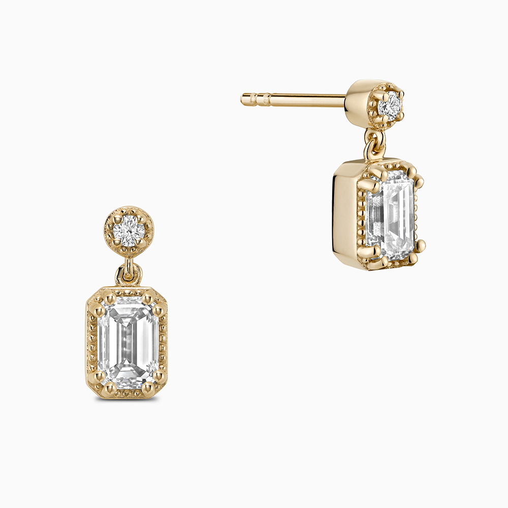 Face view of Ecksand's Emerald Diamond Stud Earrings with Milgrain Halo and Diamond Accent in 18k Yellow Gold, Natural VS2+/ F+