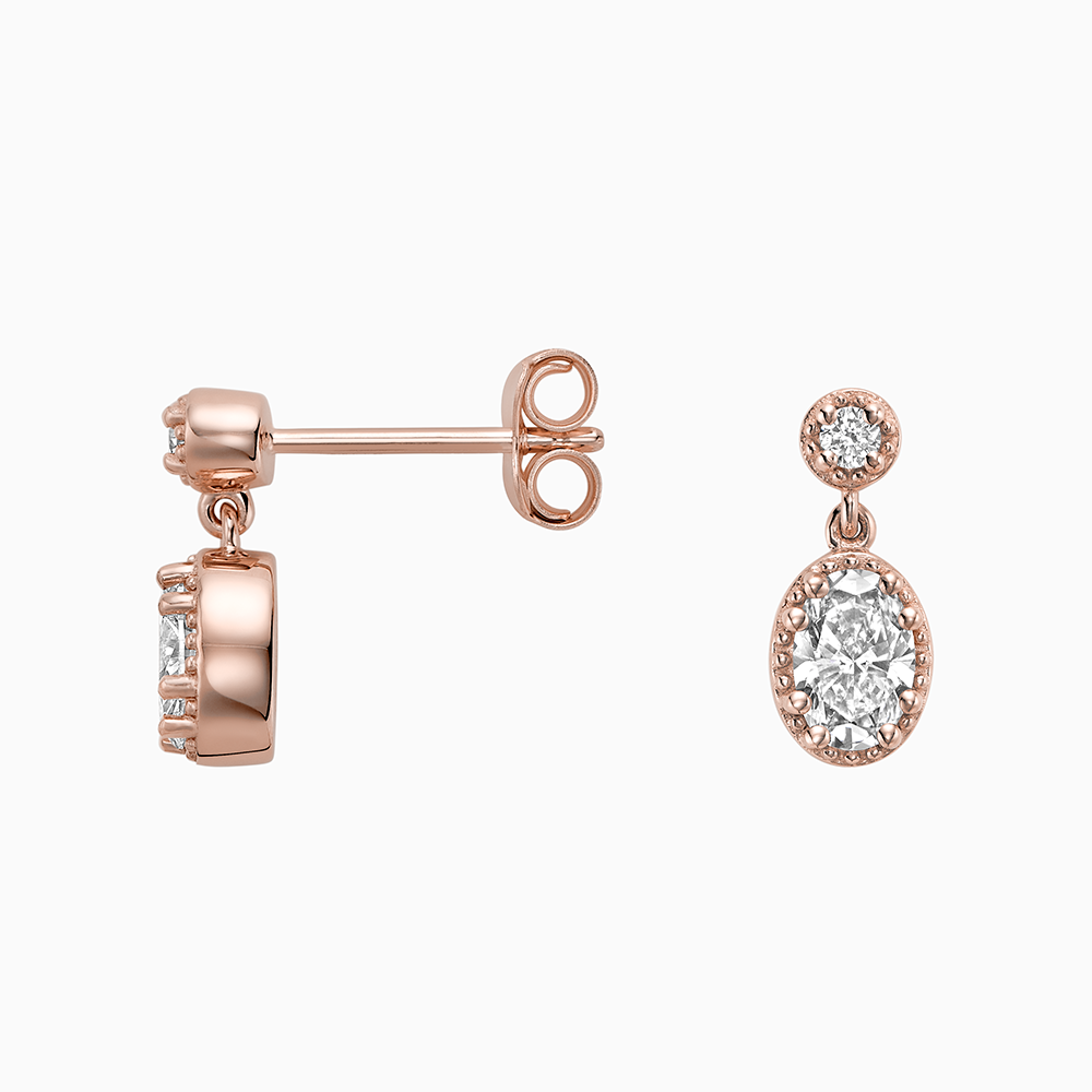 Angled view of Ecksand's Oval Diamond Stud Earrings with Milgrain Halo and Diamond Accent in 18k Rose Gold, Lab-grown VS2+/ F+