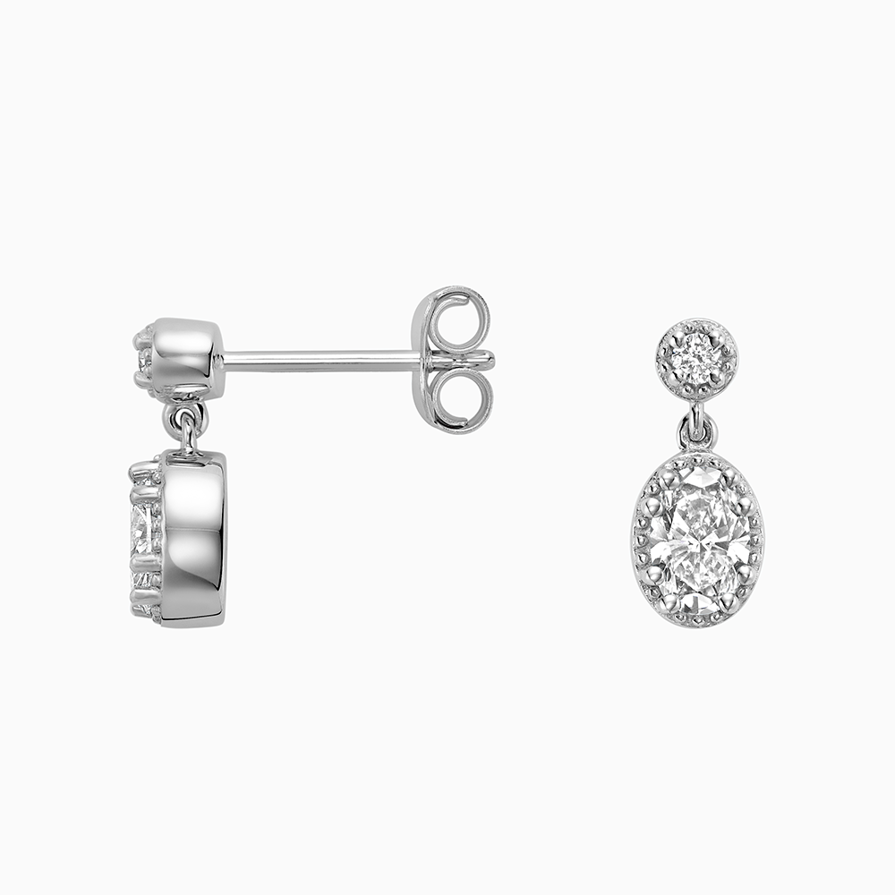 Angled view of Ecksand's Oval Diamond Stud Earrings with Milgrain Halo and Diamond Accent in 18k White Gold, Lab-grown VS2+/ F+