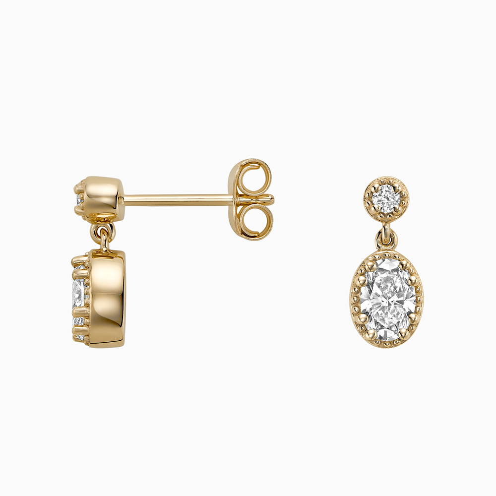 Angled view of Ecksand's Oval Diamond Stud Earrings with Milgrain Halo and Diamond Accent in 18k Yellow Gold, Lab-grown VS2+/ F+