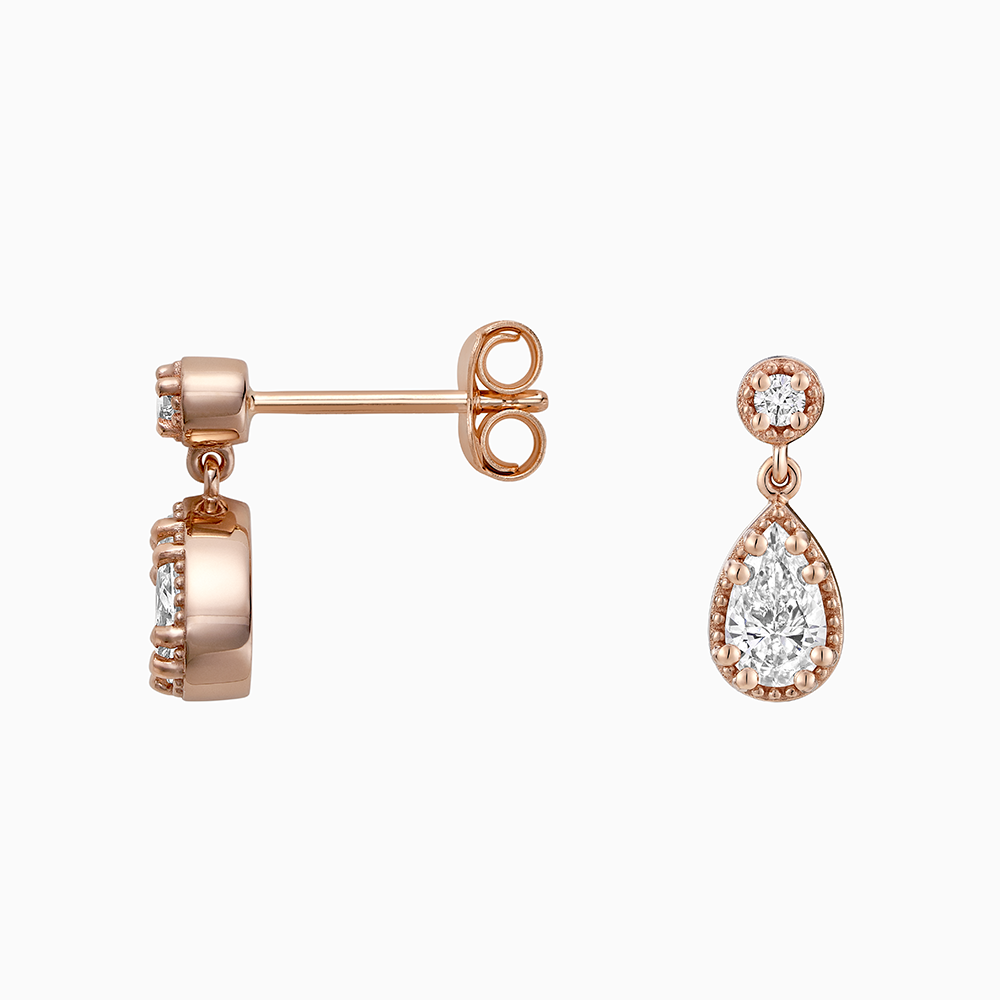 Angled view of Ecksand's Pear Diamond Stud Earrings with Milgrain Halo and Diamond Accent in 18k Rose Gold, Lab-grown VS2+/ F+