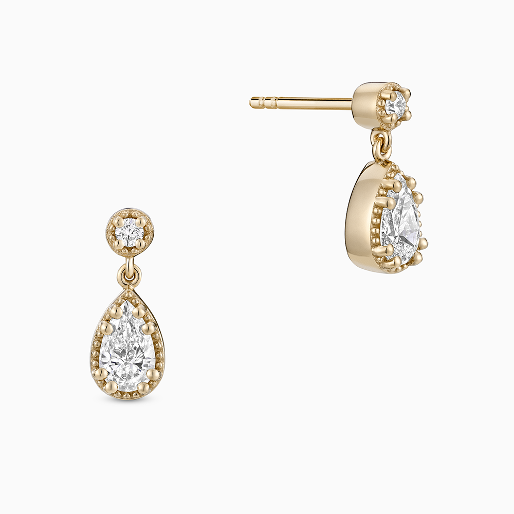 Face view of Ecksand's Pear Diamond Stud Earrings with Milgrain Halo and Diamond Accent in 18k Yellow Gold, Lab-grown VS2+/ F+