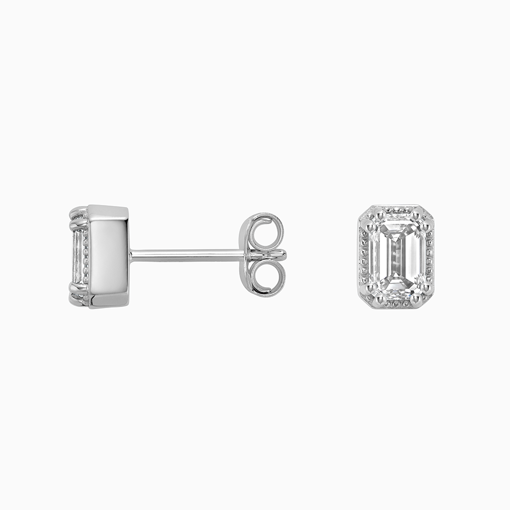 Angled view of Ecksand's Emerald Diamond Stud Earrings with Milgrain Halo in 18k White Gold, Lab-grown VS2+/ F+