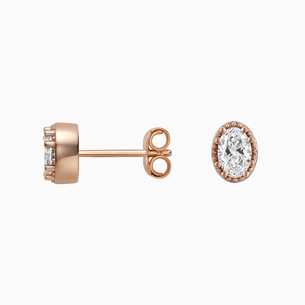 Angled view of Ecksand's Oval Diamond Stud Earrings with Milgrain Halo in 18k Rose Gold, Lab-grown VS2+/ F+