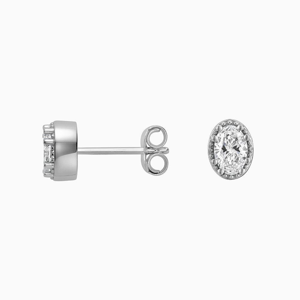 Angled view of Ecksand's Oval Diamond Stud Earrings with Milgrain Halo in 18k White Gold, Lab-grown VS2+/ F+