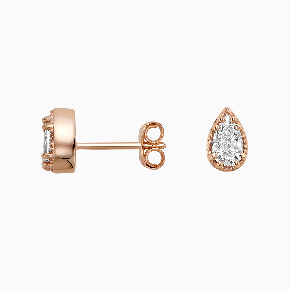 Angled view of Ecksand's Pear Diamond Stud Earrings with Milgrain Halo in 18k Rose Gold, Lab-grown VS2+/ F+