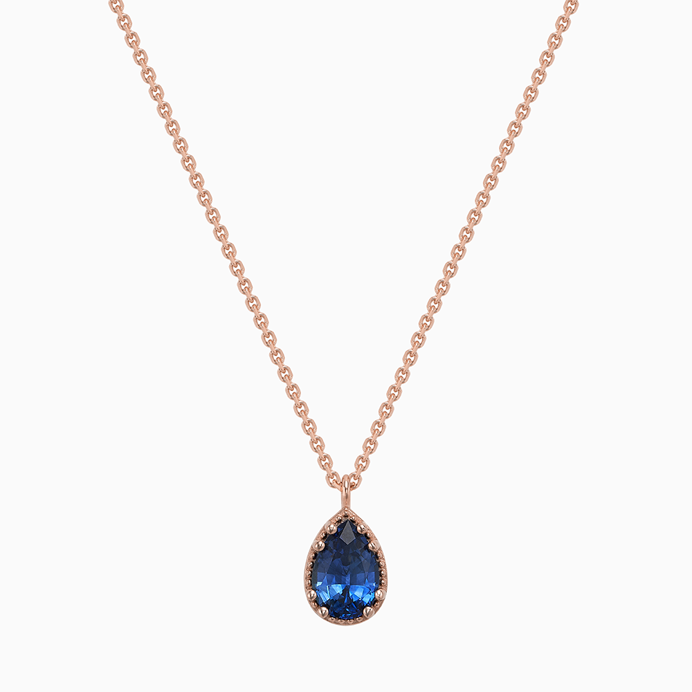 Face view of Ecksand's Pear Blue Sapphire Stackable Necklace with Milgrain Halo in 18k Rose Gold