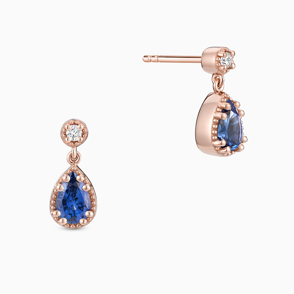 Face view of Ecksand's Pear Blue Sapphire Stud Earrings with Milgrain Halo and Diamond Accent in 18k Rose Gold, Lab-grown VS2+/ F+