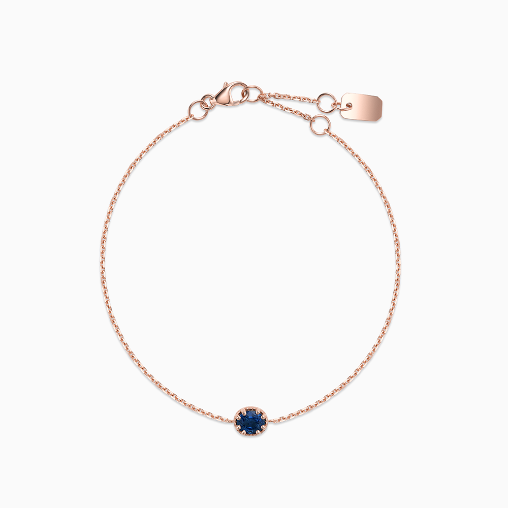 Face view of Ecksand's Oval Blue Sapphire Stackable Bracelet with Milgrain Halo in 18k Rose Gold