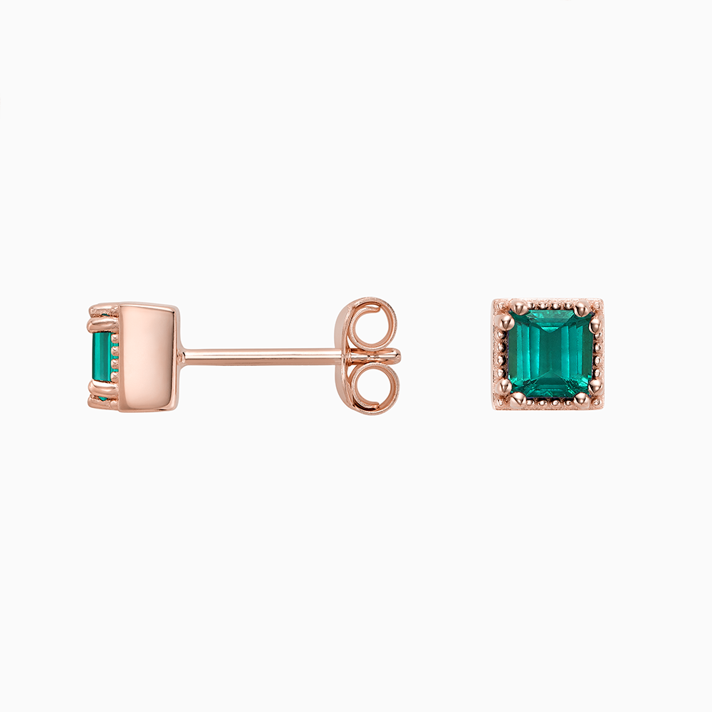 Angled view of Ecksand's Asscher Emerald Stud Earrings with Milgrain Halo in 18k Rose Gold