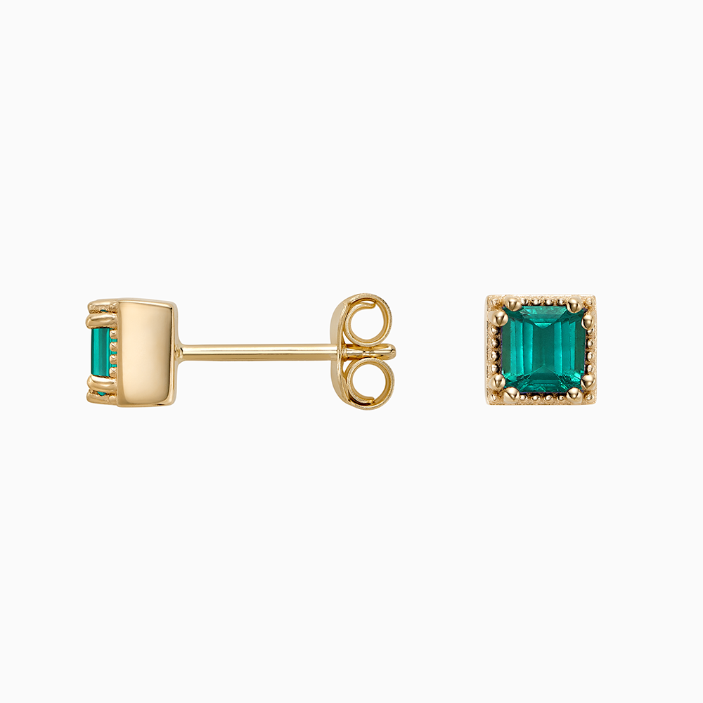 Angled view of Ecksand's Asscher Emerald Stud Earrings with Milgrain Halo in 18k Yellow Gold