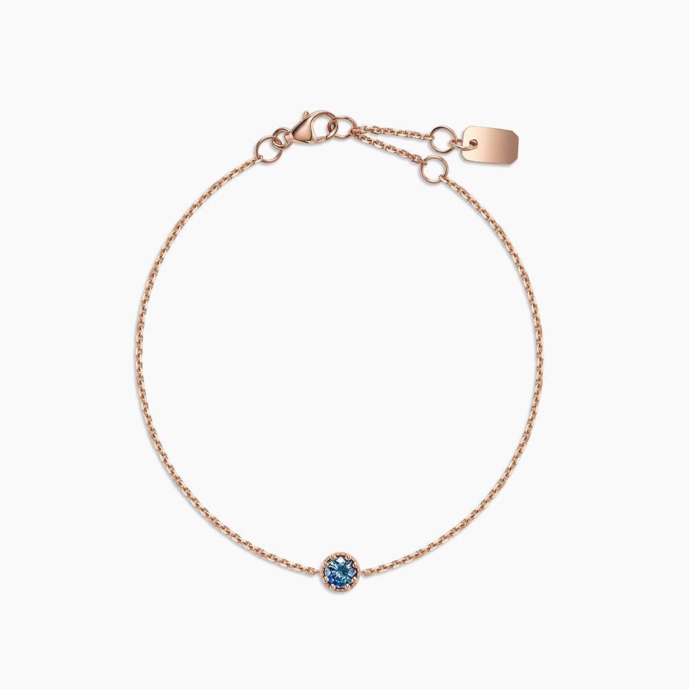 Face view of Ecksand's Round Montana Sapphire Stackable Bracelet with Milgrain Halo in 18k Rose Gold