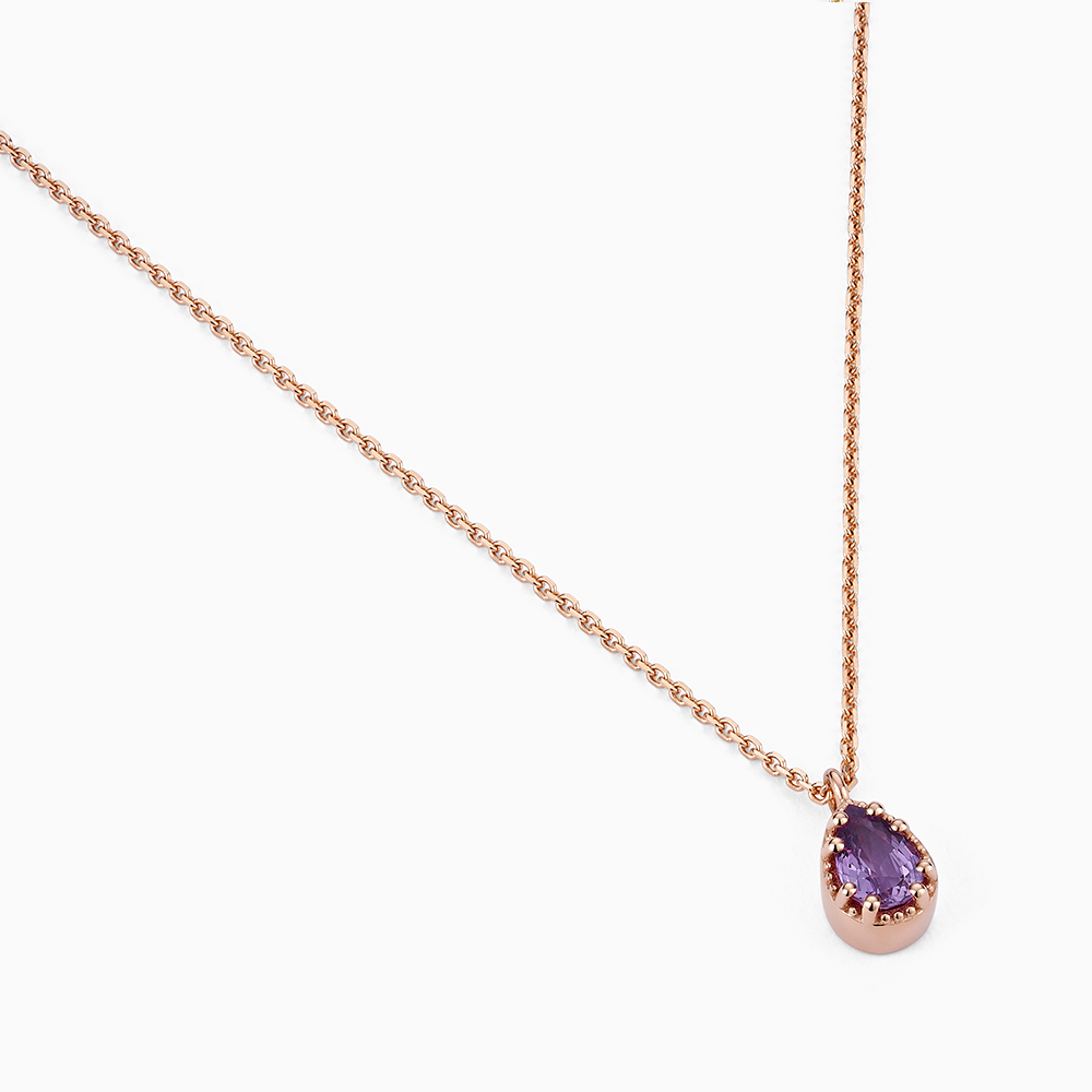 Angled view of Ecksand's Pear Purple Sapphire Stackable Necklace with Milgrain Halo in 18k Rose Gold