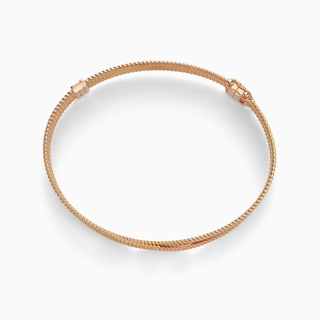 The Ecksand Twisted Gold Bangle shown with  in 