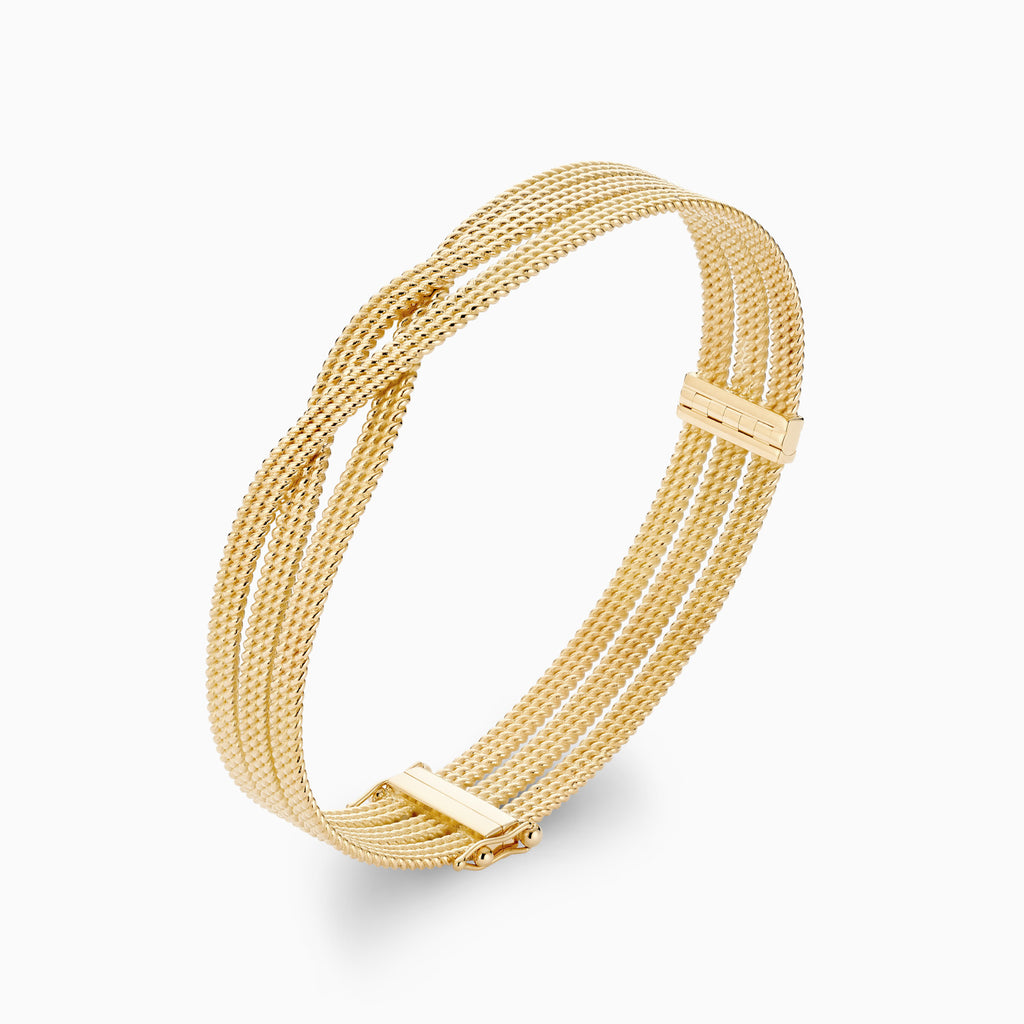 The Ecksand Twisted Gold Bangle shown with  in 